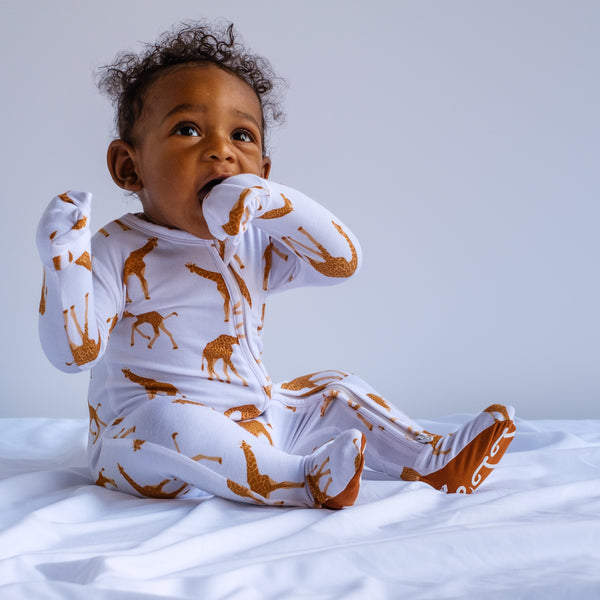 baby infant toddler boy in zip up romper with feet. giraffe print. Bamboo viscose fabric. Soft, stretchy, long fit and good for eczema and sensitive skin