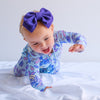 Purple bow headband on crawling baby